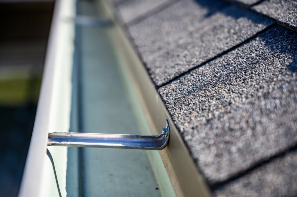 clean empty gutter on side of roof - A1 Pro Roofing Ottawa Kanata Orleans