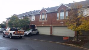 roofing project complete, brick townhouses in a row with pristine roofs - A1 Pro Roofing Ottawa Kanata Orleans