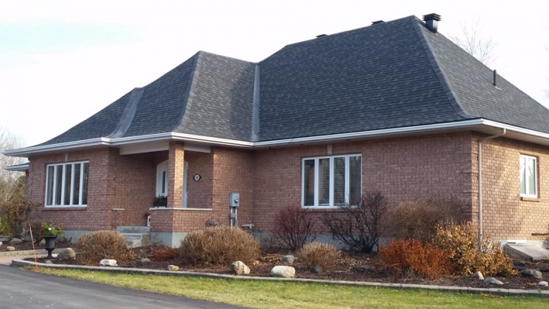 roofing project complete, brick bungalow with steep dark shingled roof - A1 Pro Roofing Ottawa Kanata Orleans